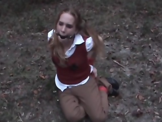Coed hogtied and ballgagged in woods