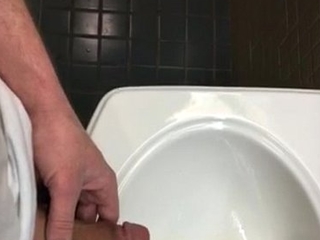 Pissing involving Sink public bathroom